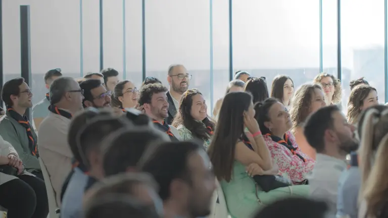 Diverse audience engaged at a conference event.